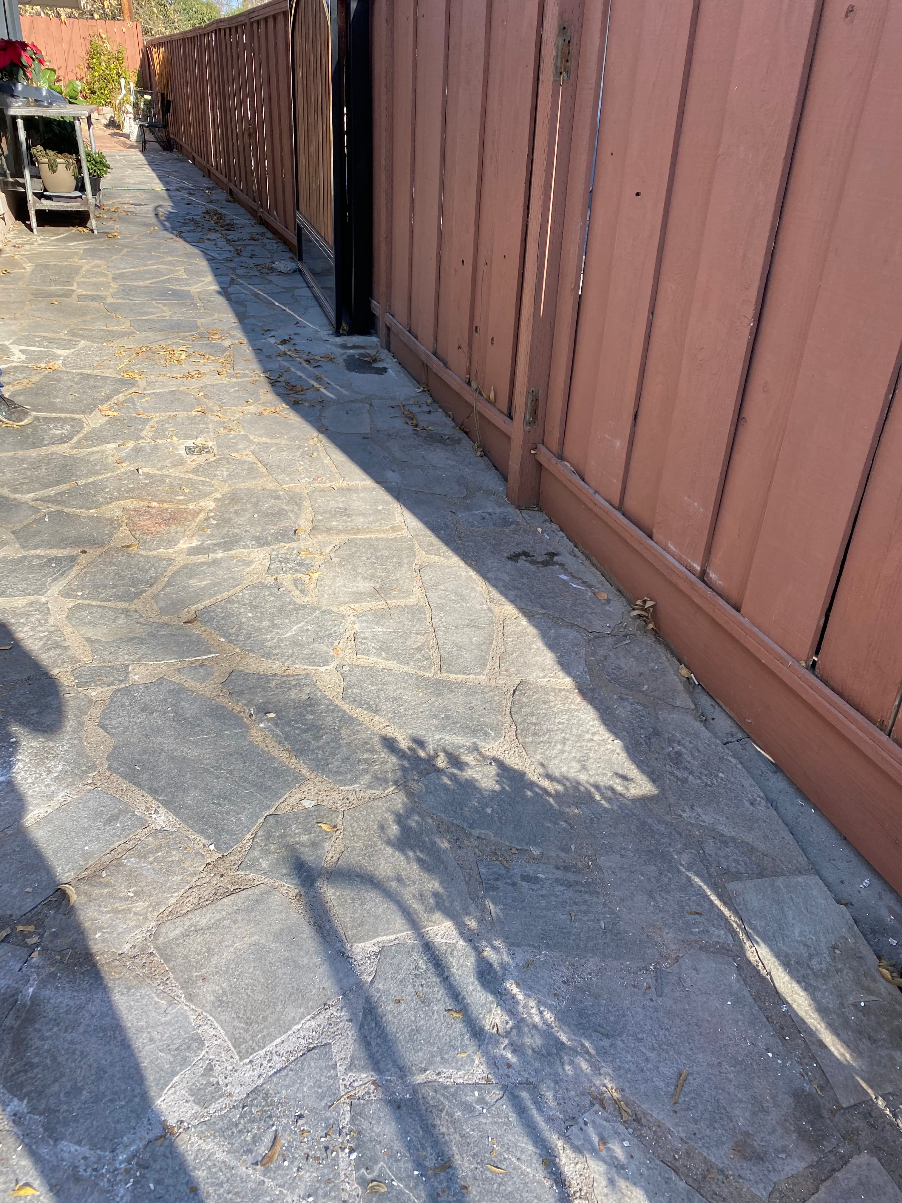 Kitchen with bare subfloor after Servant King removed the tile